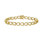 Gold horseshoe and diamond bracelet on a white background