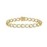 Gold horseshoe and diamond bracelet on a white background