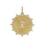 A medium-sized yellow gold medallion with a sun-like design and encrusted with diamonds around the border.