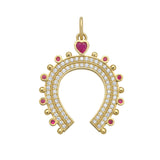 Gold horseshoe-shaped charm with gemstones and diamonds on a white background