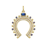 Gold horseshoe-shaped charm with gemstones and diamonds on a white background