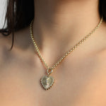 gold and diamond heart charm on a rolo link chain