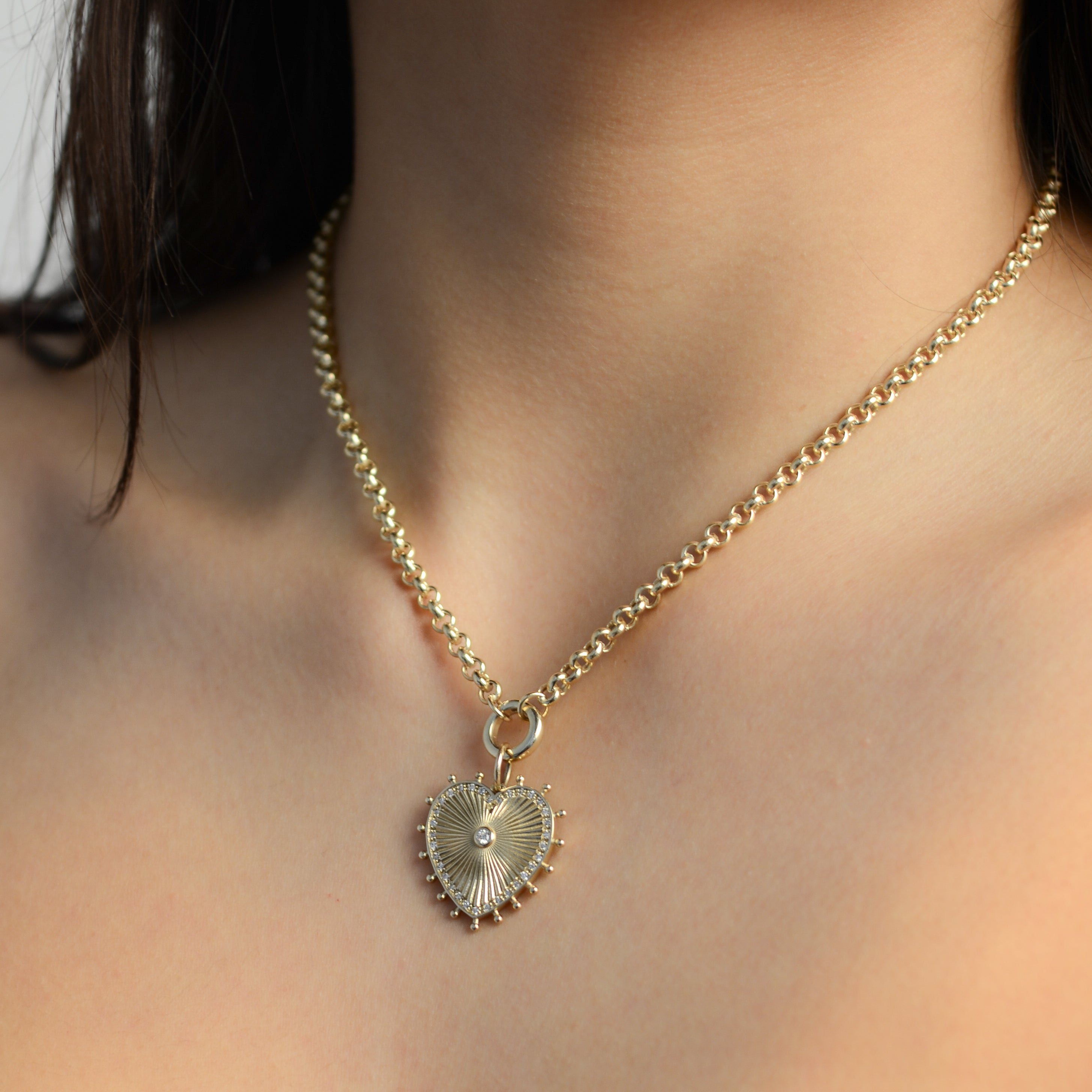 gold and diamond heart charm on a rolo link chain