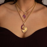 Model wearing ruby crescent moon charm necklace in 14K gold
