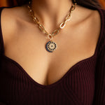 Model wearing sapphire crescent moon charm on gold chain