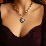 Model wearing sapphire crescent moon charm on gold chain