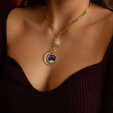 Gold necklace with lapis medallion, diamond moon charm, and diamond starburst pendant worn on model