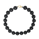 Black beaded necklace with a gold clasp on a white background