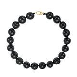 Black beaded necklace with a gold clasp on a white background